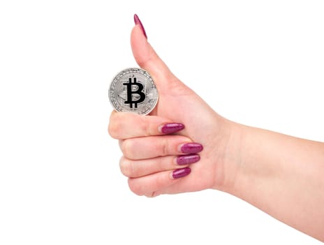 Silver bitcoin coin in female hand on white background
