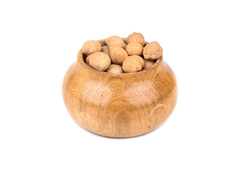 Dry chickpeas in a wooden capacitance isolated on white background