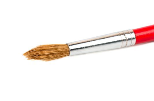 Red paint brush closeup on white background
