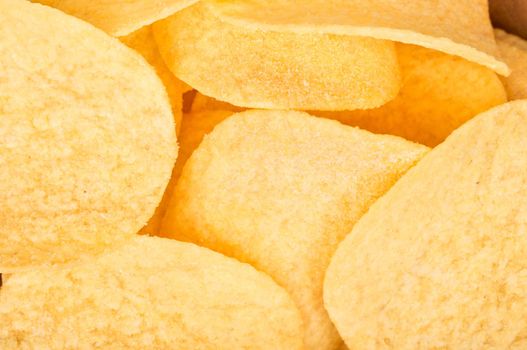 Pile of potato chips with cheese flavor close up