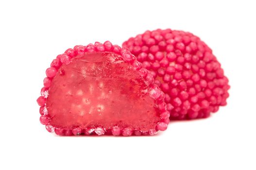 Red berry jelly candy with half on a white background