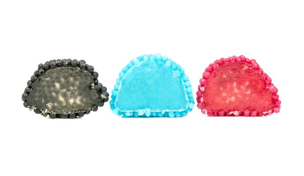 Three halves of multicolored berry jelly sweets on a white background