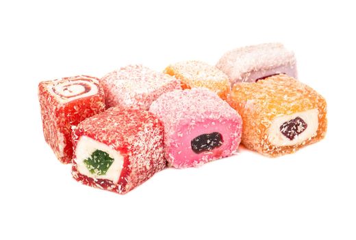 Several pieces of turkish delight on a white background