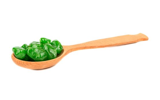 Dried kumquat lime in a wooden spoon isolated on white background