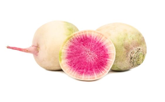 Fresh watermelon radishes and half on a white background