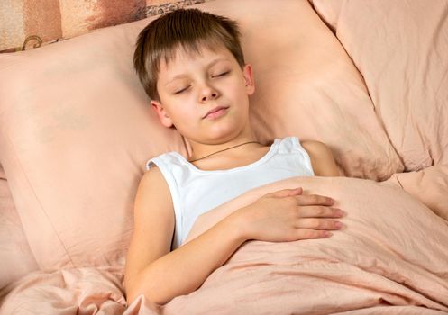 Portrait of a young boy who sleeps in the bed