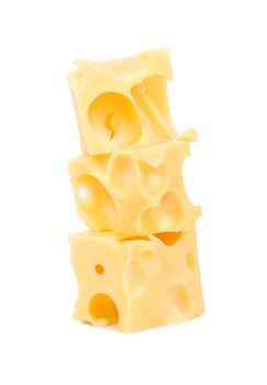 Three cubes of cheese with holes on a white background