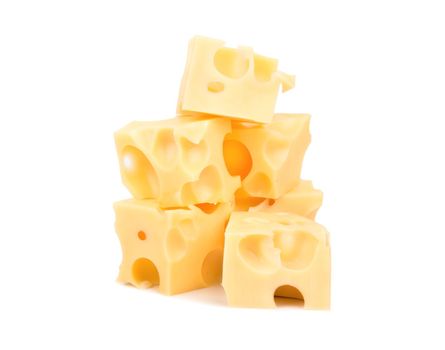 Several cubes of cheese with holes on a white background
