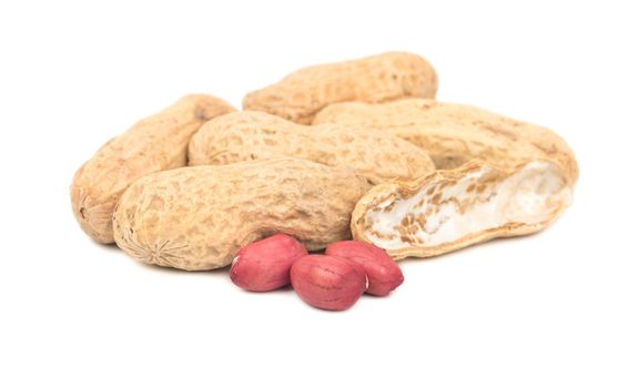Several peanuts in a shell with three cores on a white background