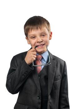 Portrait of a schoolboy holding the teeth in glasses on white background