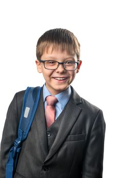 Laughing schoolboy wearing glasses with a backpack on a white background