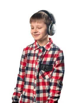 Little boy enjoys music in headphones over white background