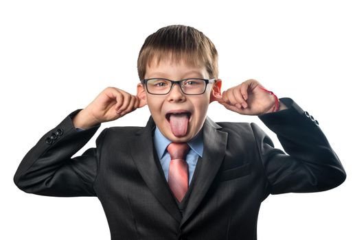 Portrait of a schoolboy wearing glasses showing a tongue close-up