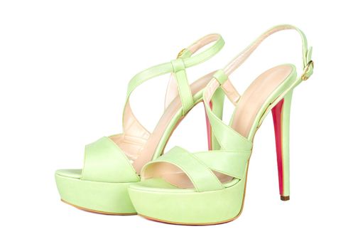 Green womens high-heeled sandals on white background