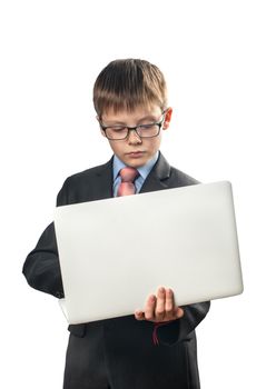 Schoolboy holding a laptop and communicating on the Internet on a white background