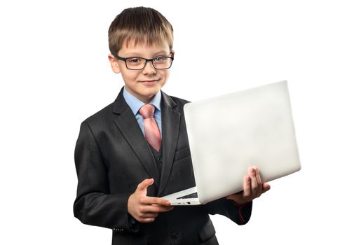 Portrait of a schoolboy holding a laptop in his hands on a white background