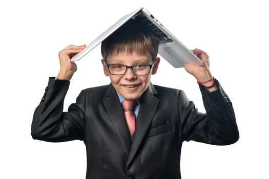 Cheerful schoolboy dressed on a laptop head on a white background