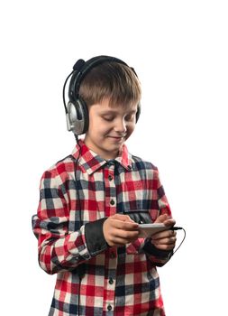 Boy listening to music on headphones with a smartphone on a white background