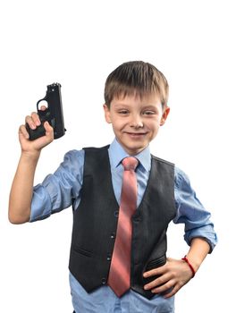 Boy in a tie is holding a gun in his hand on a white background