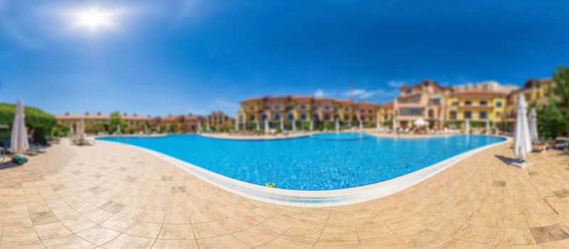 Pool with pure blue water background. Top view of swimming pool and floor texture. Panorama of pool bottom with tile pattern and transparent water. Summer travel and vacation background concept.