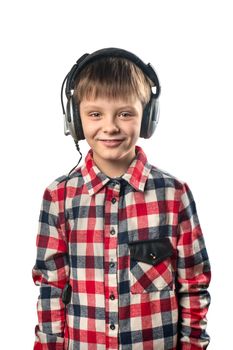 Portrait of a little boy listening to music in headphones on a white background