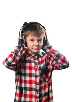 Little boy enjoys music in headphones over white background