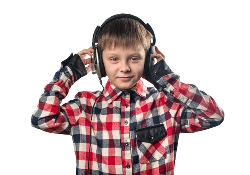 Portrait of a little boy listening to music in headphones on a white background
