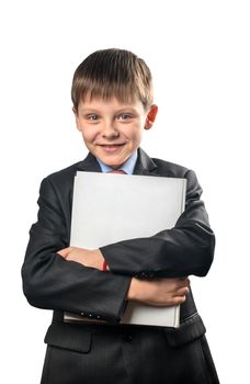 Cheerful schoolboy holding book in hands on a white background