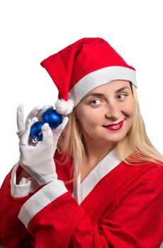 Girl in costume of Santa Claus with Christmas balls in the hands
