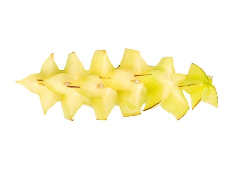 Fresh carambola fruit cut into slices on white background, top view
