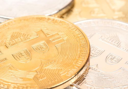 Scattered gold and silver coins bitcoin close-up