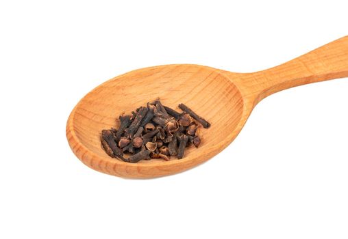 Big spoon with the dry spice cloves isolated on white background closeup