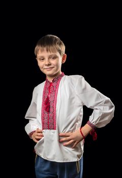 Beautiful boy in a white traditional Ukrainian shirt on a black background