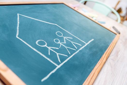 confined family drawn on a blackboard, concept of quarantine with children