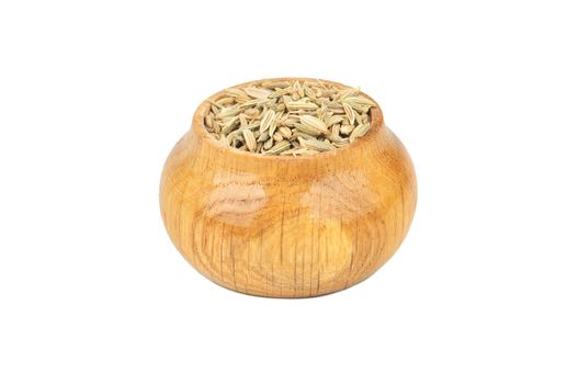 Spice dry fennel in wooden container isolated on white background