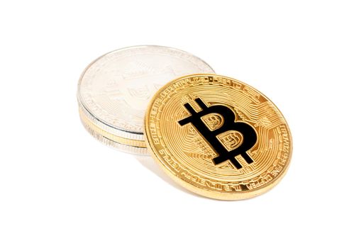 Stack of gold and silver bitcoins on a white background