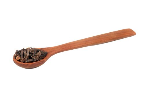 Dry cloves in wooden spoon isolated on white background