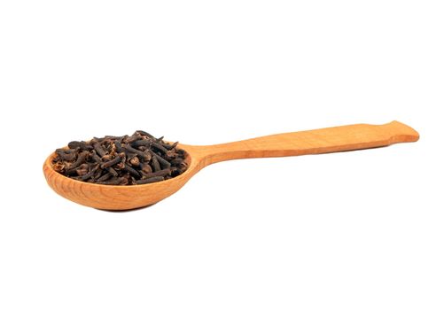 Wooden spoon with dry spice cloves on white background