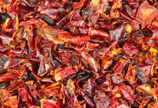 Background of pieces of dry red pepper closeup