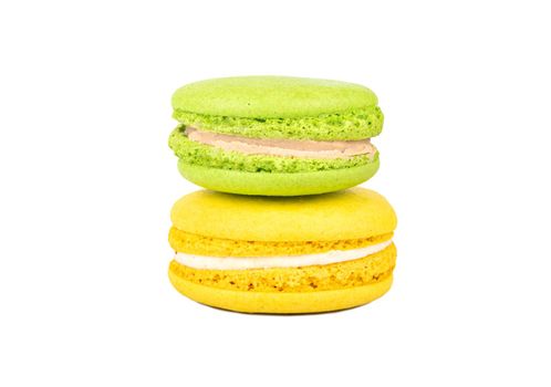 Pistachio and lemon macaroons isolated on white background