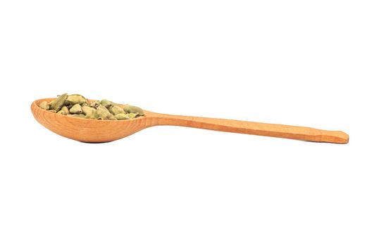 Large wooden spoon with dry cardamom isolated on white background