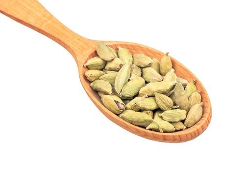 Large wooden spoon with dry cardamom isolated on white background closeup