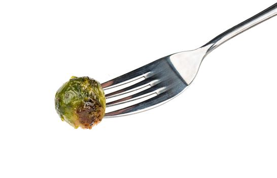 Fried brussels sprouts on fork isolated on a white background