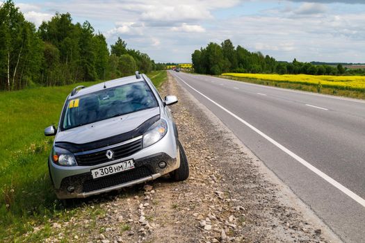 silver renault sandero stepway on verge of interstate road at summer day in Tula, Russia - June 4, 2022