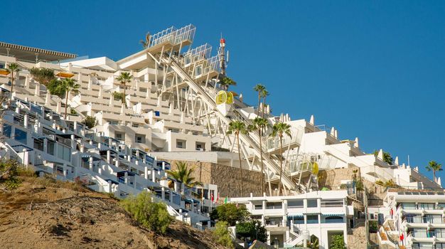 16 February 2022 very beautiful landscape of Puerto Rico Canary Islands a beach resort and luxury hotels set on a slope with swimming pools and cable car surrounded by palm trees