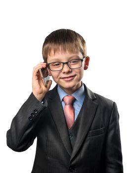 Schoolboy wearing glasses calling on smartphone on white background