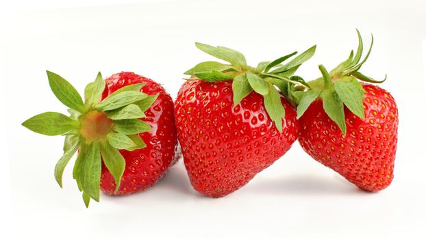 Three ripe strawberries isolated on white background.