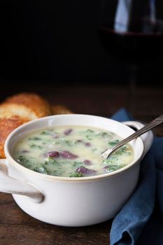 Portuguese Caldo Verde soup with spoon. Vertical format with copy space.