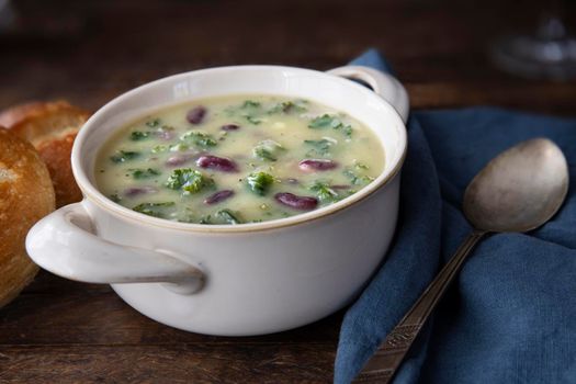 Portuguese Caldo Verde soup with spoon .