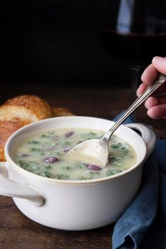 Portuguese Caldo Verde soup with spoon. Vertical format with copy space.
